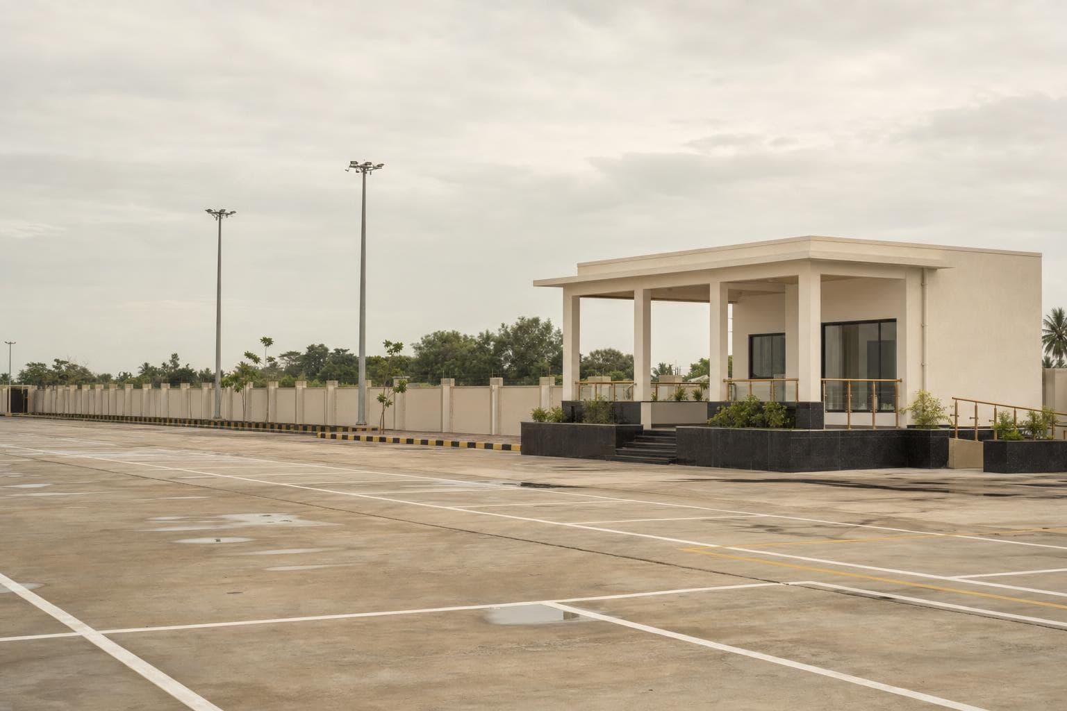 Paved municipal truck terminal with marked parking bays and a control office